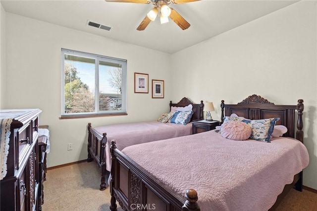 bedroom with a ceiling fan, visible vents, light carpet, and baseboards