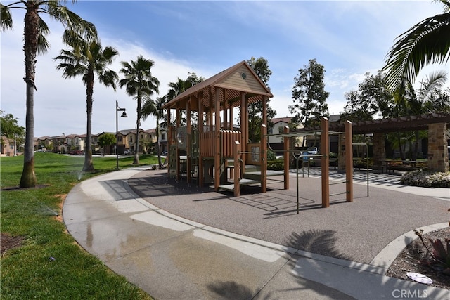 community jungle gym featuring a yard