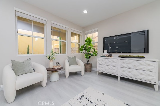 sitting room featuring baseboards, wood finished floors, and recessed lighting