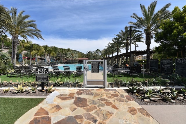 view of patio / terrace with a community pool and fence