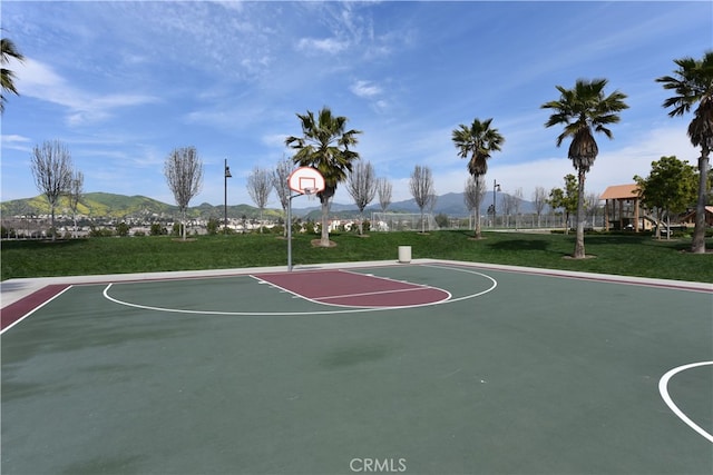 view of basketball court featuring community basketball court, a yard, and a mountain view