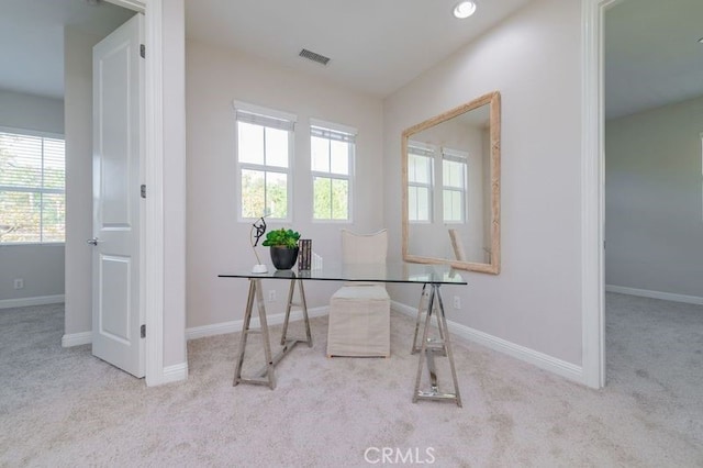 carpeted office space with visible vents and baseboards