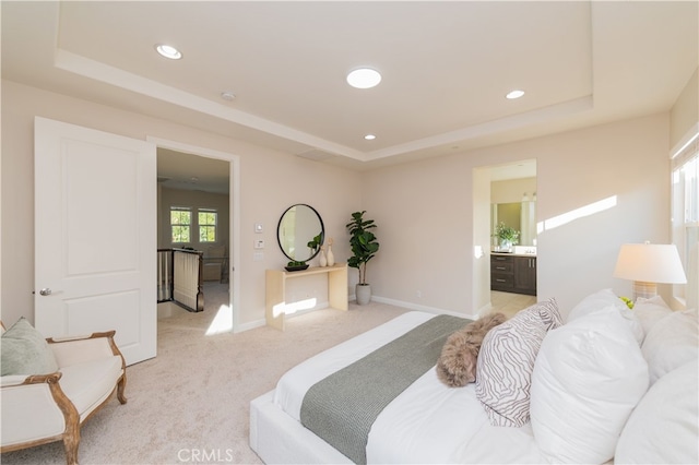 bedroom with recessed lighting, a raised ceiling, and baseboards