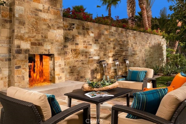 view of patio featuring an outdoor living space with a fireplace