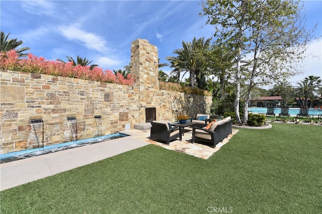 view of yard featuring a patio, fence, a community pool, and an outdoor hangout area