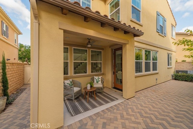 view of patio featuring fence and ceiling fan