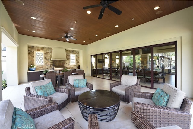 view of patio / terrace featuring outdoor dining space, an outdoor living space with a fireplace, ceiling fan, and grilling area