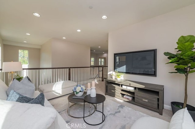 carpeted living area featuring baseboards and recessed lighting