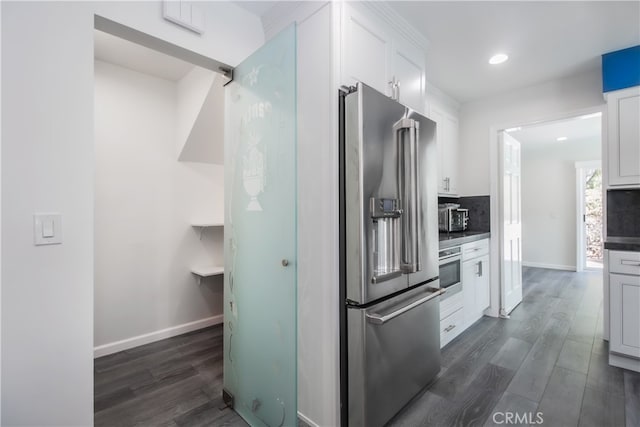 6 Bronco Ln, Bell Canyon, CA 91307 - kitchen featuring decorative backsplash, white cabinets, stainless steel appliances, and dark wood-type flooring