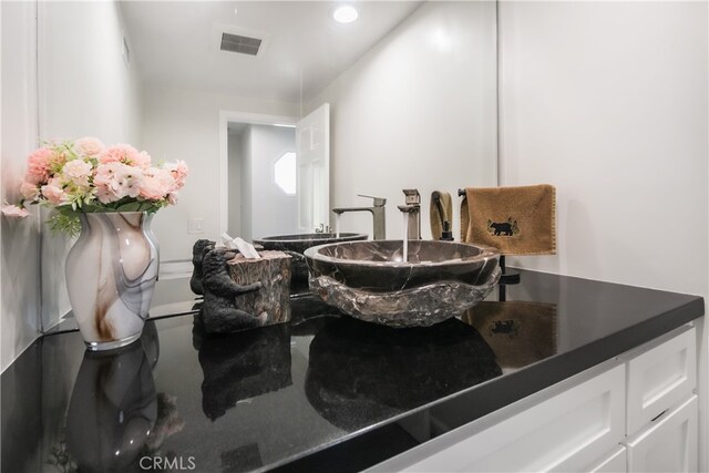 bathroom with visible vents and vanity