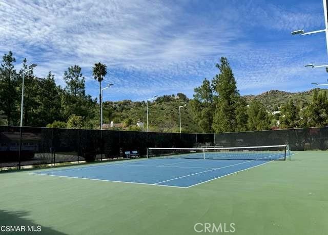 view of tennis court with fence