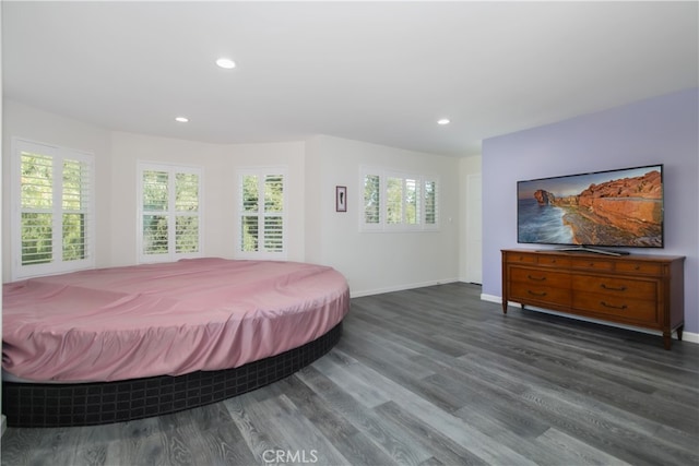 bedroom with baseboards, wood finished floors, and recessed lighting