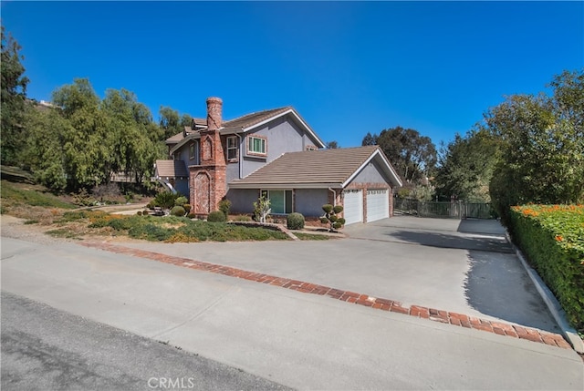 6 Bronco Ln, Bell Canyon, CA 91307 - view of front facade with a garage, a chimney, concrete driveway, stucco siding, and fence