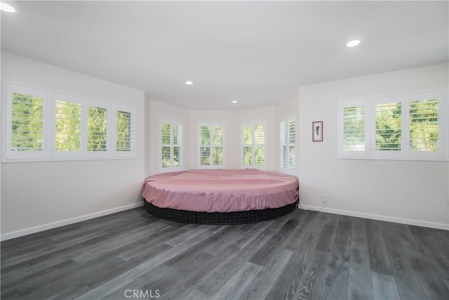 bedroom with recessed lighting, dark wood finished floors, and baseboards