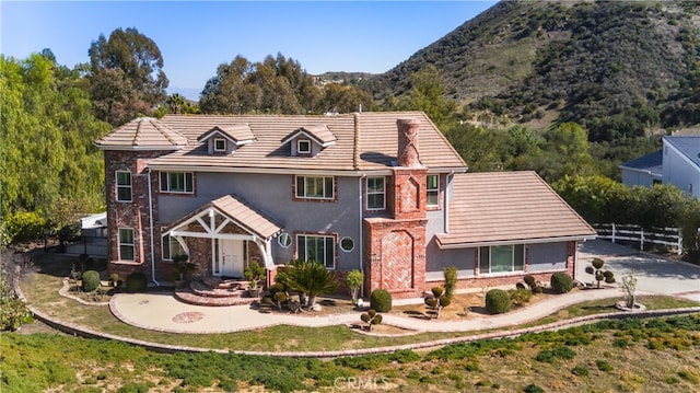 6 Bronco Ln, Bell Canyon, CA 91307 - view of front of house featuring stucco siding, fence, a mountain view, and brick siding