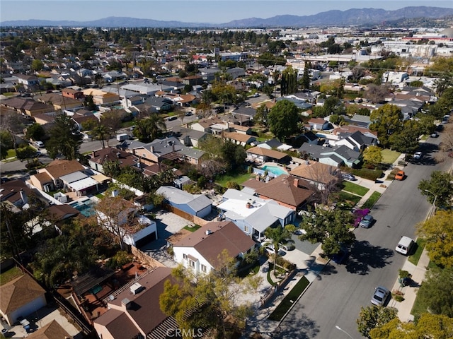 birds eye view of property with a mountain view and a residential view