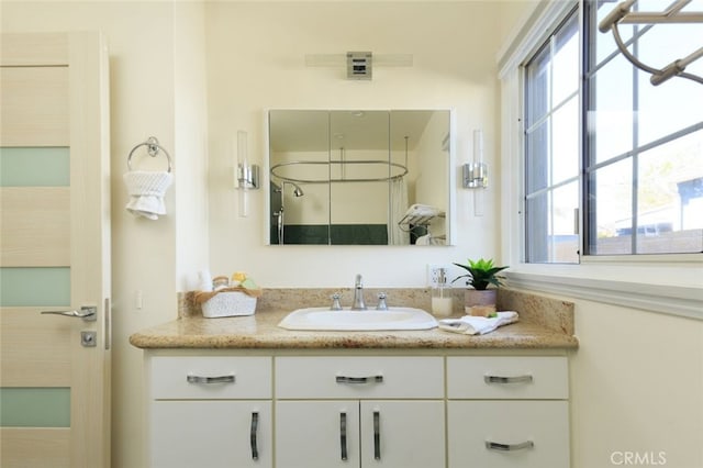 bathroom featuring a healthy amount of sunlight and vanity