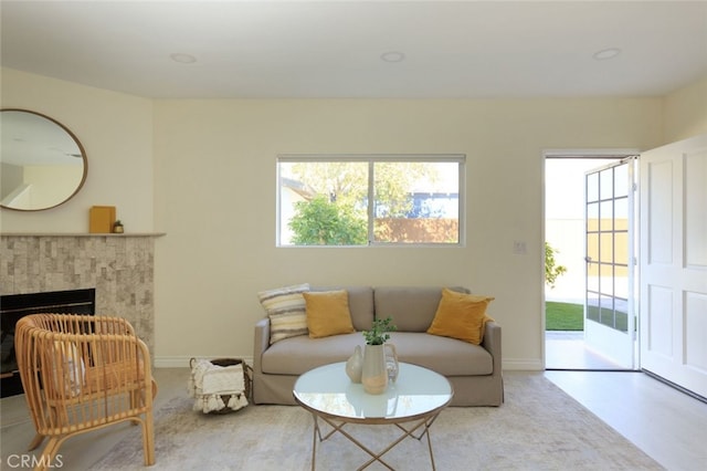 living room with baseboards and a high end fireplace