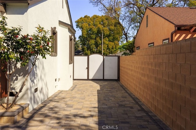 view of patio with a gate and fence