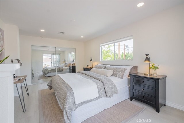 bedroom with recessed lighting, visible vents, a closet, and baseboards