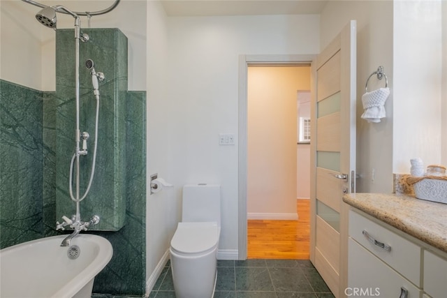 bathroom featuring a shower, a freestanding tub, toilet, and vanity