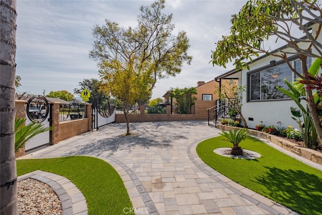 view of community with a fenced front yard and a gate