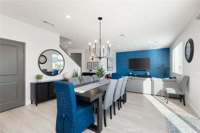 dining space with a chandelier, light wood finished floors, visible vents, and recessed lighting