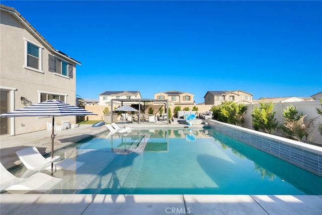 view of swimming pool with a patio area, a fenced backyard, and a fenced in pool