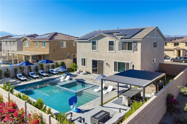 view of pool with a fenced backyard, a residential view, a pool with connected hot tub, and a patio