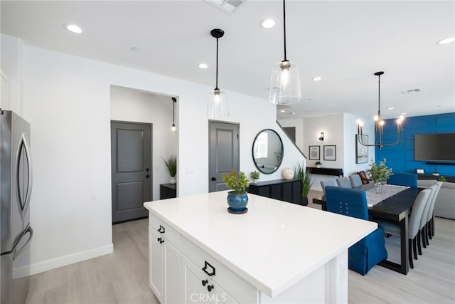 kitchen with freestanding refrigerator, visible vents, and recessed lighting