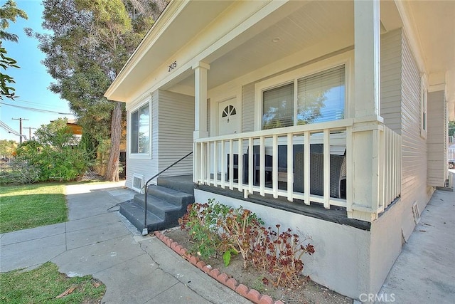 entrance to property featuring a porch