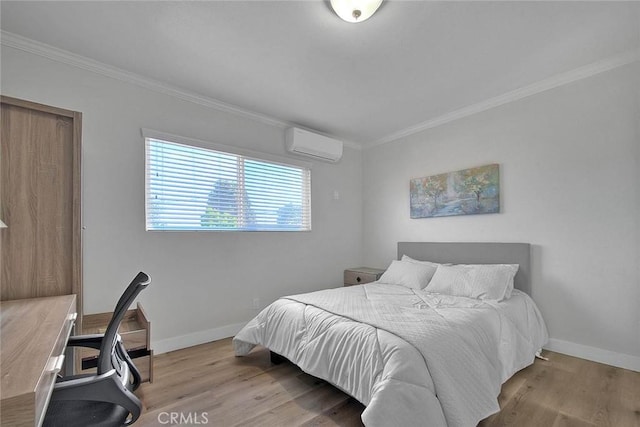 bedroom featuring baseboards, an AC wall unit, and wood finished floors