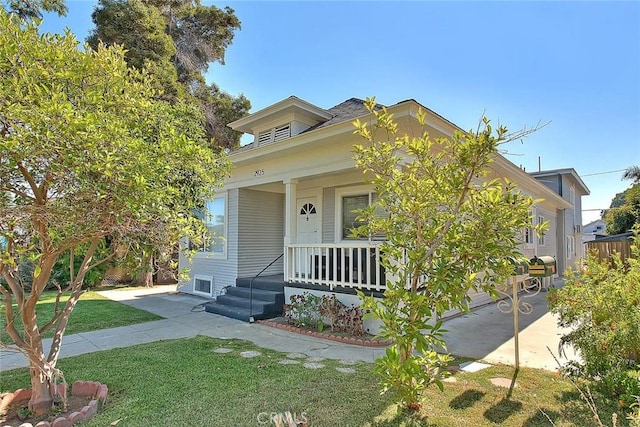 view of front of home with a porch and a front yard