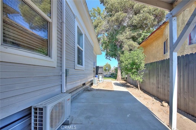 view of property exterior featuring ac unit, a patio area, fence, and central air condition unit