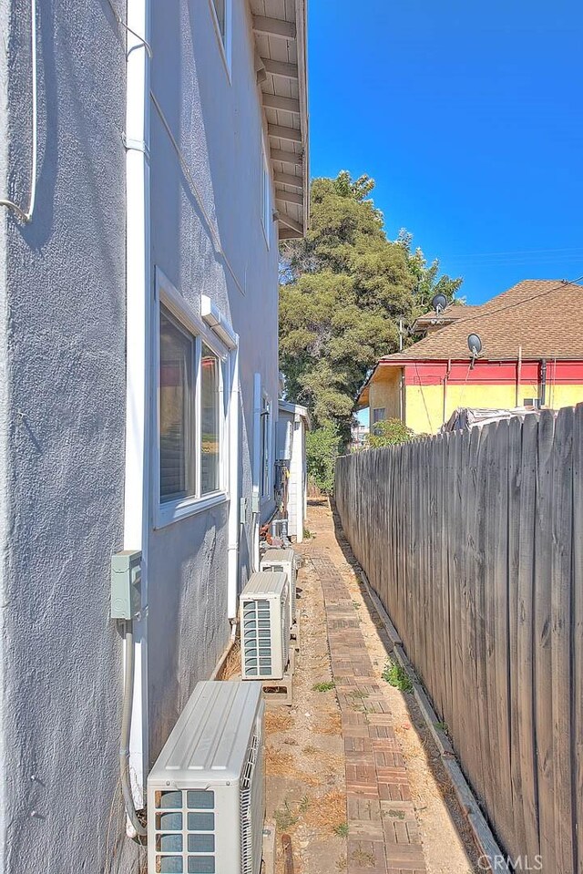 view of patio / terrace featuring ac unit and fence