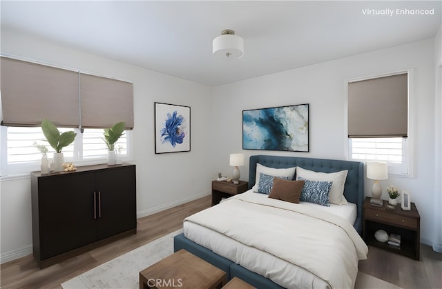 bedroom with light wood-style flooring and baseboards