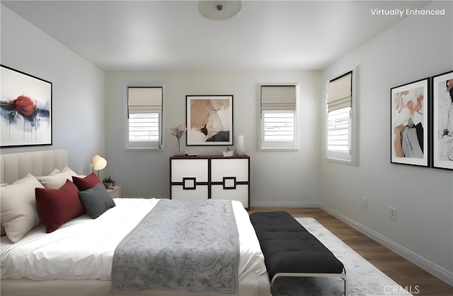 bedroom with baseboards and wood finished floors