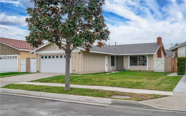 ranch-style home with a garage, driveway, a gate, fence, and a front yard