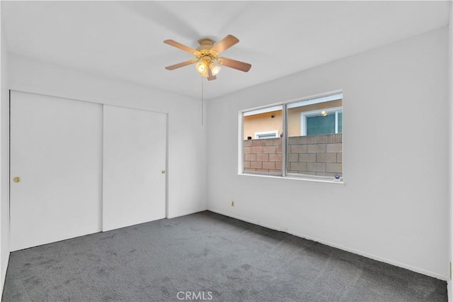 unfurnished bedroom featuring ceiling fan, a closet, and carpet