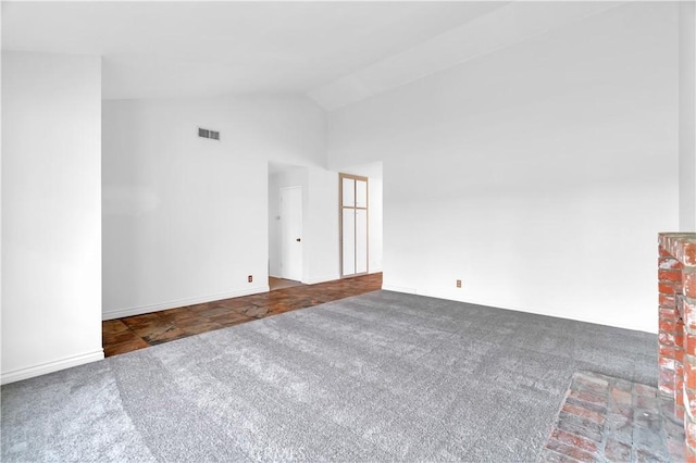 spare room featuring high vaulted ceiling, carpet, and visible vents