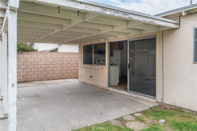 view of patio featuring an attached carport