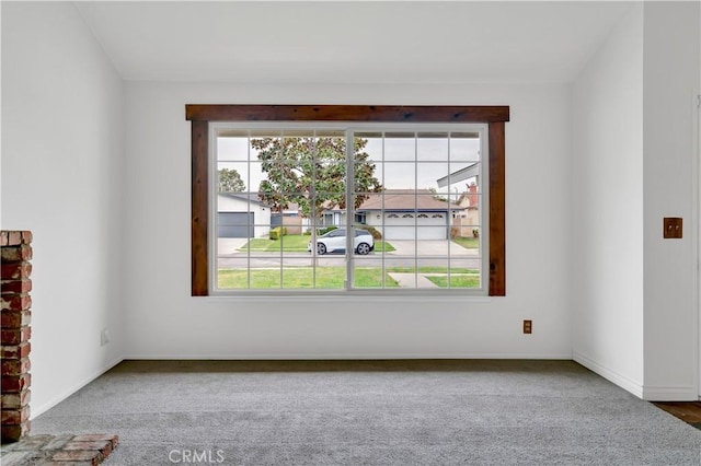 unfurnished room with carpet floors, a wealth of natural light, and baseboards