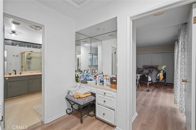 full bathroom with visible vents, vanity, a shower, and wood finished floors