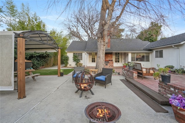 view of patio / terrace featuring an outdoor living space with a fire pit and fence