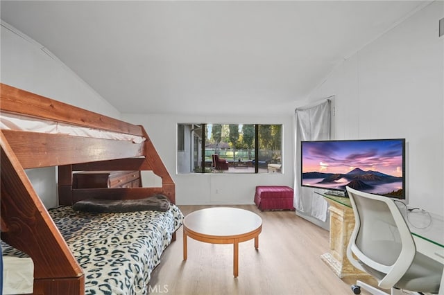 bedroom featuring wood finished floors and vaulted ceiling