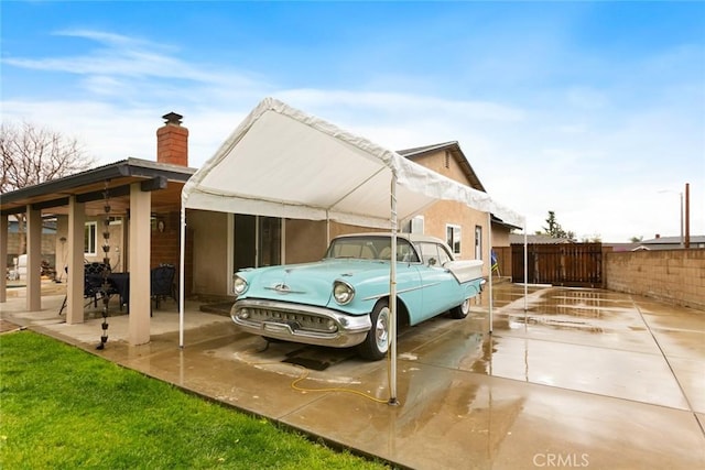 exterior space with fence and a carport