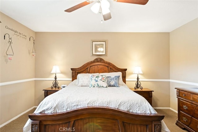 bedroom with dark colored carpet, a ceiling fan, and baseboards