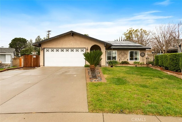 single story home with driveway, a garage, solar panels, a front lawn, and stucco siding