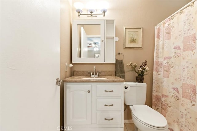 full bath featuring curtained shower, vanity, and toilet