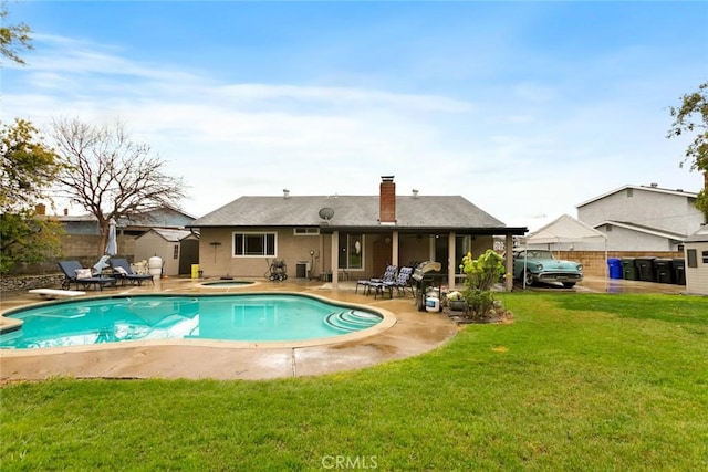 view of pool with a fenced in pool, a patio, an in ground hot tub, fence, and a yard